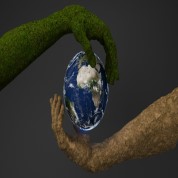 Two hands — one covered in green moss and one made of earth — holding a globe, symbolising sustainability and environmental responsibility in industry.